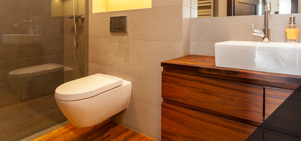 Dark wooden vanity unity with a white sink and toilet